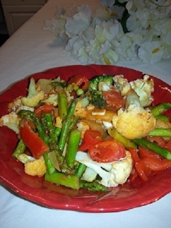 A red plate of food with vegetables on it.