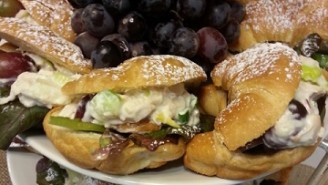 A stack of pastries and grapes on plates.