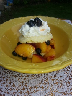 A yellow plate topped with fruit and whipped cream.