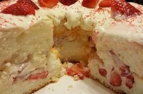 A cake with strawberries on top of it.