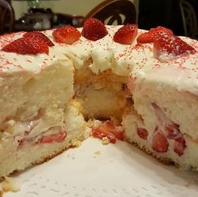 A cake with strawberries on top of it.