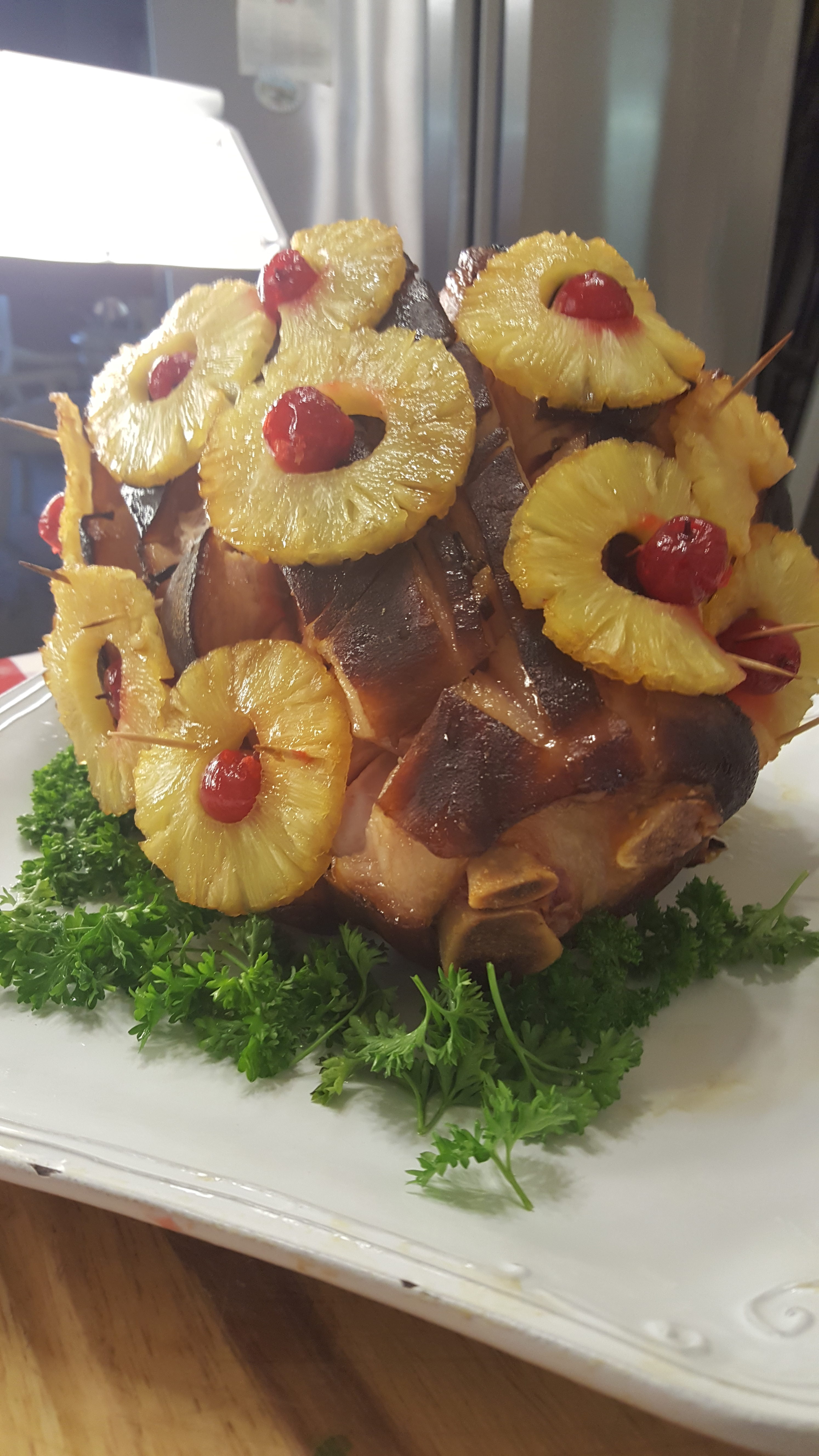 A pineapple and bacon dish on top of green parsley.