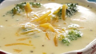 A bowl of broccoli and cheese soup.