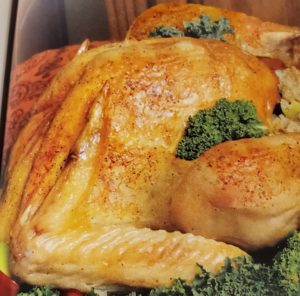 A close up of a chicken with broccoli