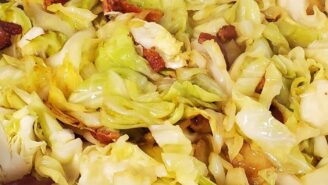 A close up of some cabbage and bacon in the pan