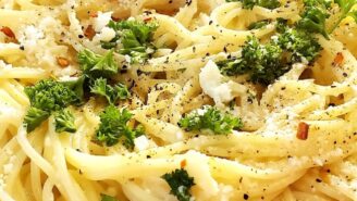 A plate of pasta with cheese and herbs.