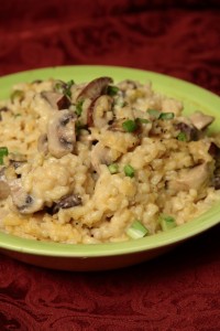 A bowl of rice and mushrooms on the table.