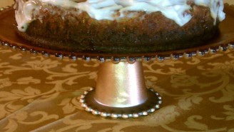 A cake on top of a metal stand.