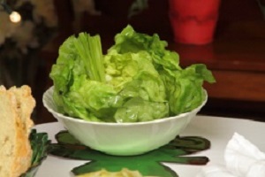 A bowl of lettuce on the table