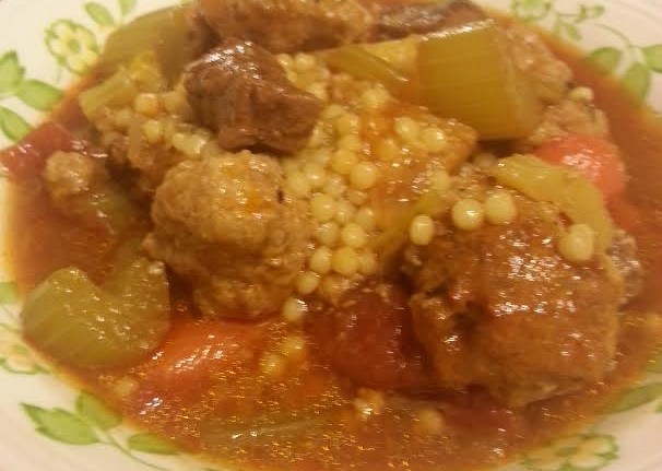 A plate of stew with meat and vegetables.