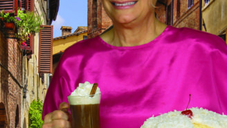 A woman holding a plate with cake on it.
