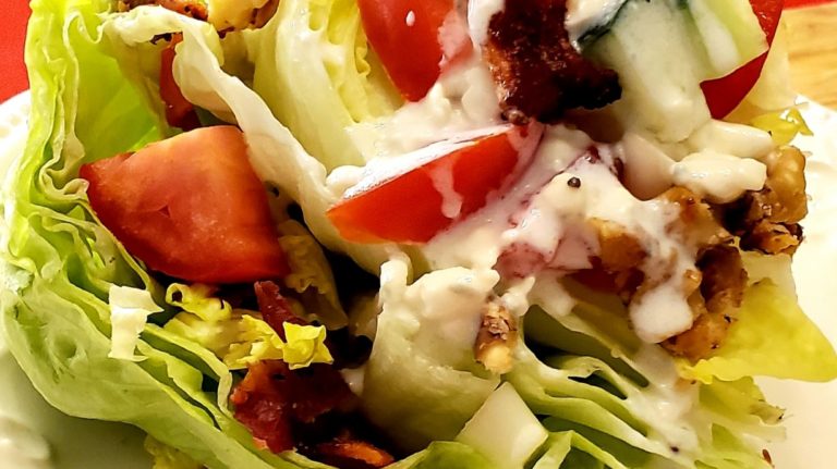 A salad with dressing on top of it.